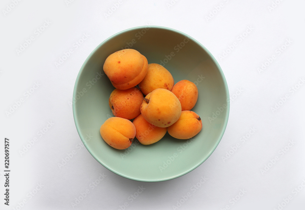 Apricots in green bowl close up from above Apricots in green bowl close up from above
