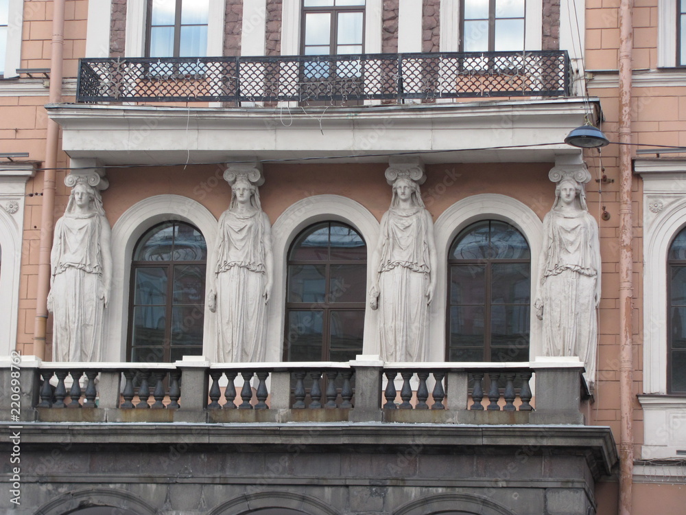 Atlanteans and caryatids as a decoration of the facade of the building