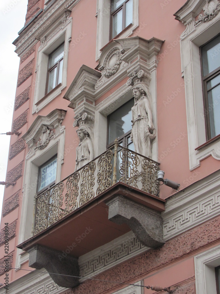 Atlanteans and caryatids as a decoration of the facade of the building