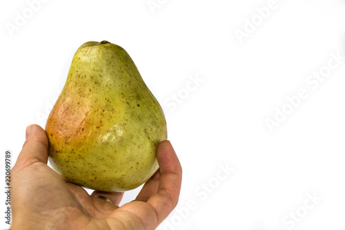 Pear in hand isolated on white background.
