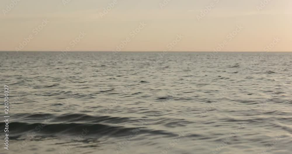 Slow motion waves on a beach on a windy sunny evening Slow motion waves on a beach on a windy sunny evening
