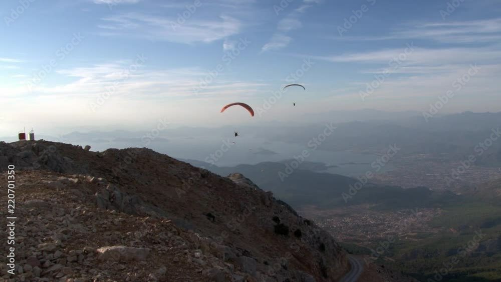 Oludeniz Paragliding near the city Fethiye from Babadag mountain in Turkey. Feeling of adrenaline, extreme, euphoria and freedom at height of bird's flight. Awesome energy of ascending air currents. Oludeniz Paragliding near the city Fethiye from Babadag mountain in Turkey. Feeling of adrenaline, extreme, euphoria and freedom at height of bird's flight. Awesome energy of ascending air currents.