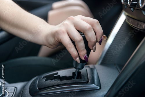 Female hand on automatic transmission car lever