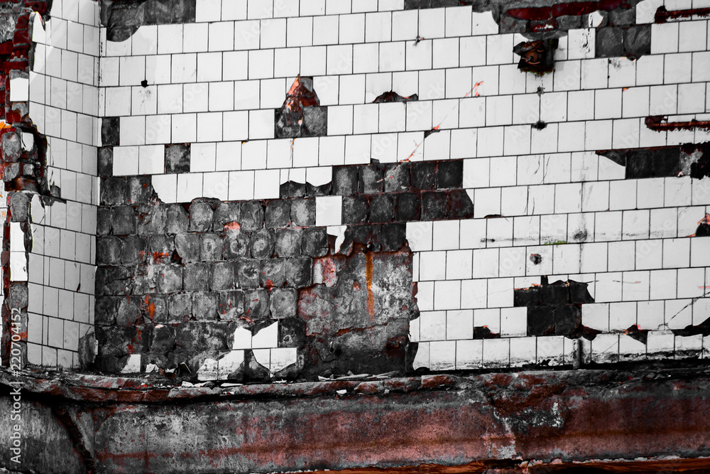 Fototapeta premium Wall with fallen off damaged white tiles