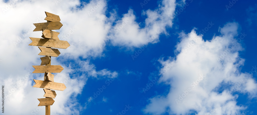 blank wooden arrow pointer against the sky blank wooden arrow pointer against the sky