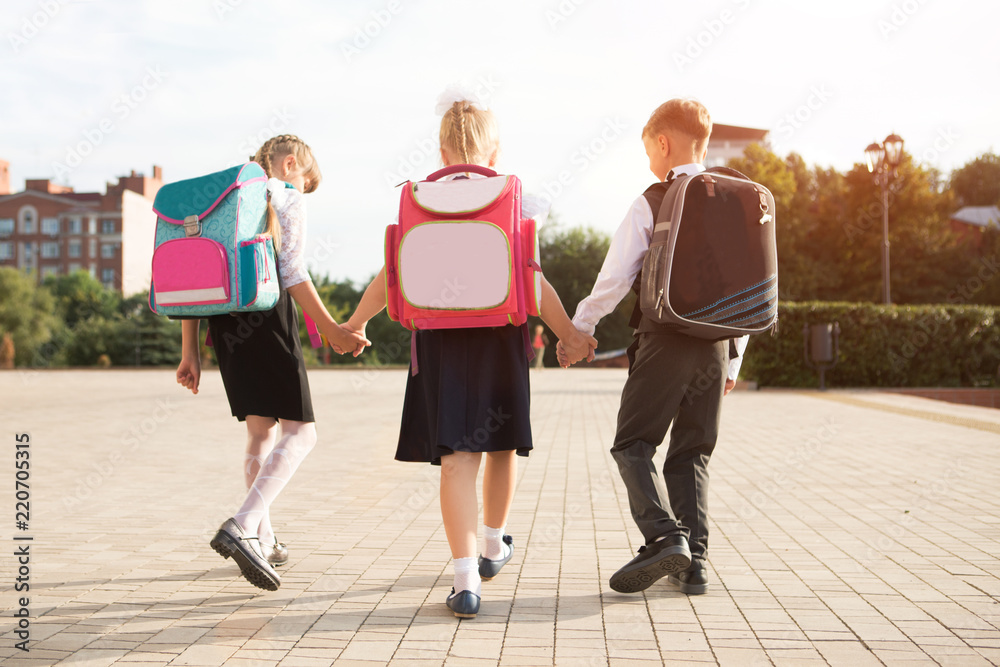 Obraz premium Group of little school kids going to school together.