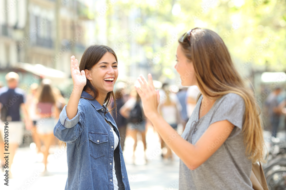 Friends meeting and greeting in the street Friends meeting and greeting in the street