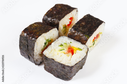 Portion of sushi with vegetables on a white background close up.
