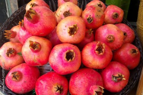 view from the top of a group of ripe pomegranates in a basket of straw for Rosh Hashana in Israel