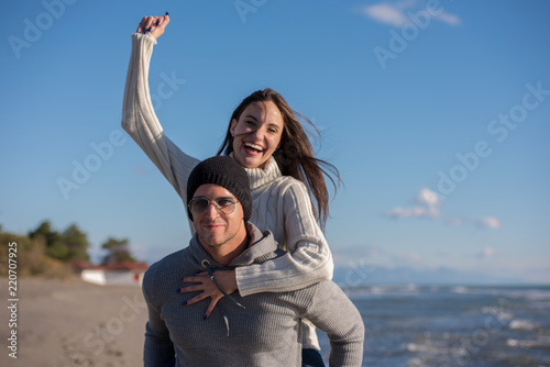 couple having fun at beach during autumn