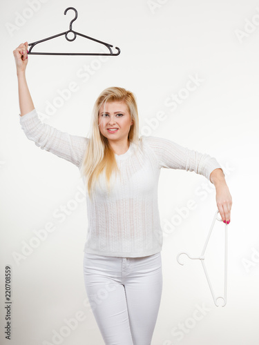 Woman holding clothes hanger photo