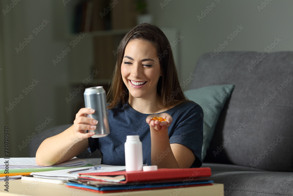 Student deciding between energy drink and vitamin pills Student deciding between energy drink and vitamin pills