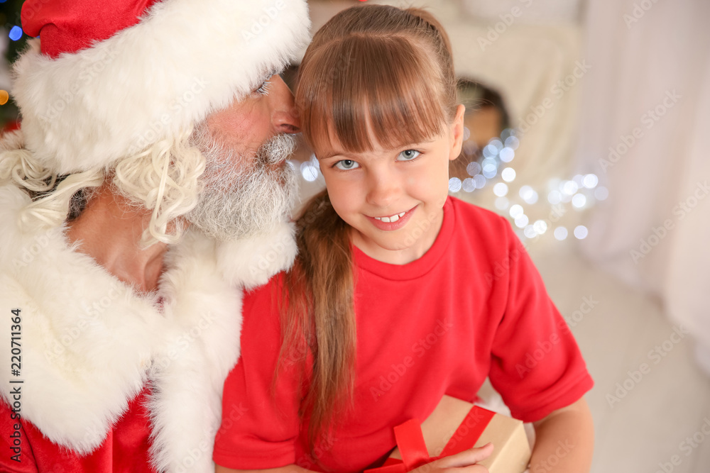 Little child with Santa Claus and Christmas gift at home Little child with Santa Claus and Christmas gift at home