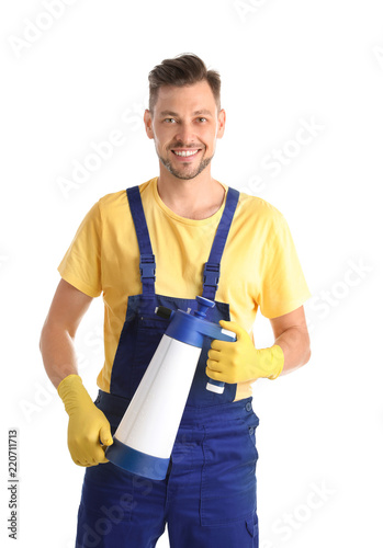 Male janitor with spray bottle of cleaning product on white background