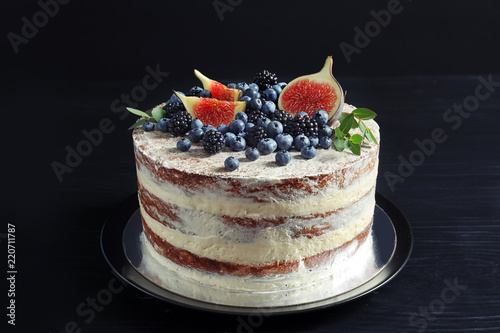 Delicious homemade cake with fresh berries on dark wooden table