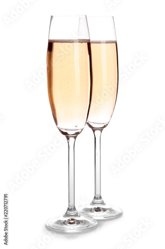 Glasses of rose champagne on white background. Festive drink