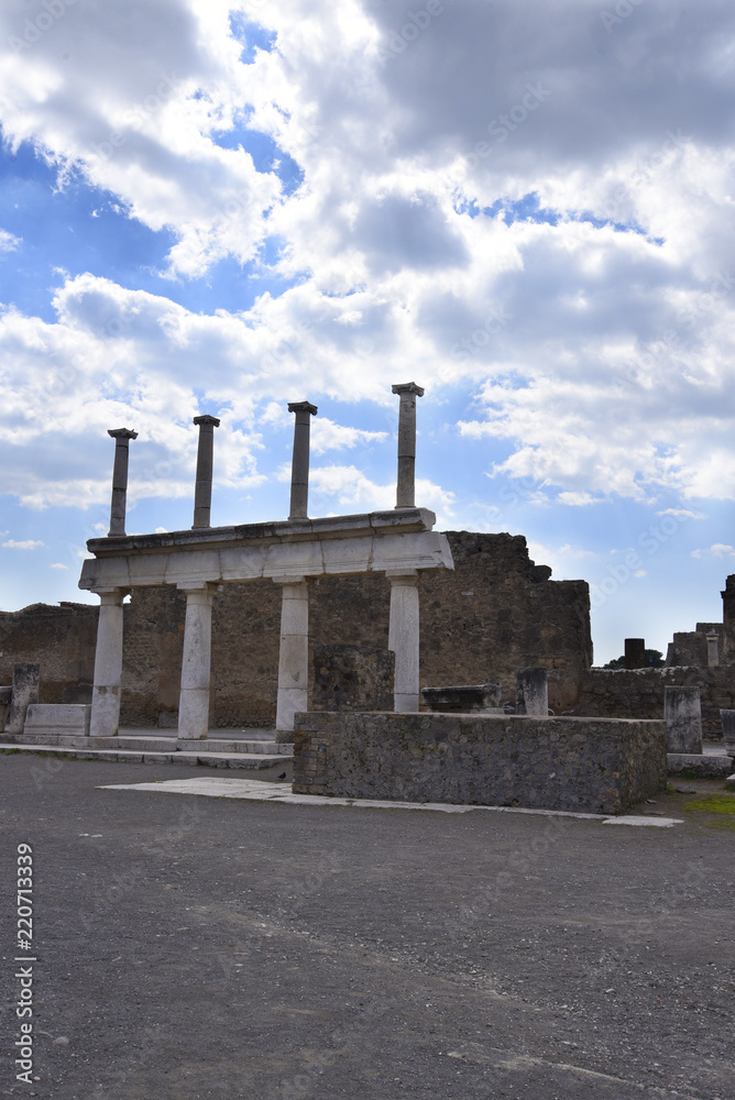 Columns in the Forum in the once buried Roman city of Pompeii south of Naples under the shadow of Mount Vesuvius Italy
