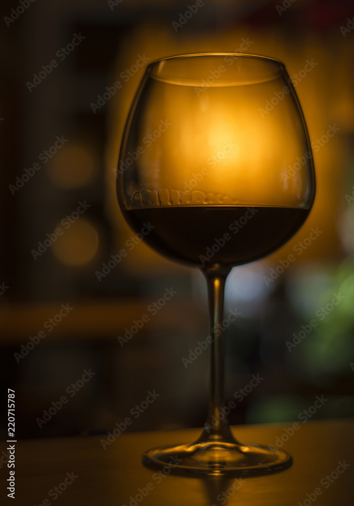 glass of red wine in dark cozy bar interior glass of red wine in dark cozy bar interior