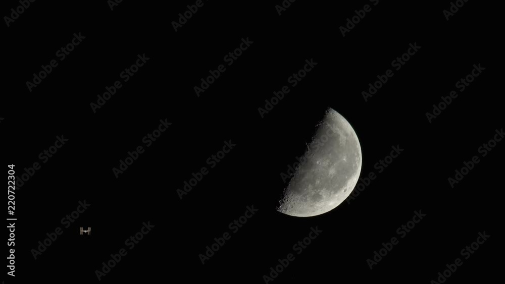 The International Space Station flying on the moon background The International Space Station flying on the moon background