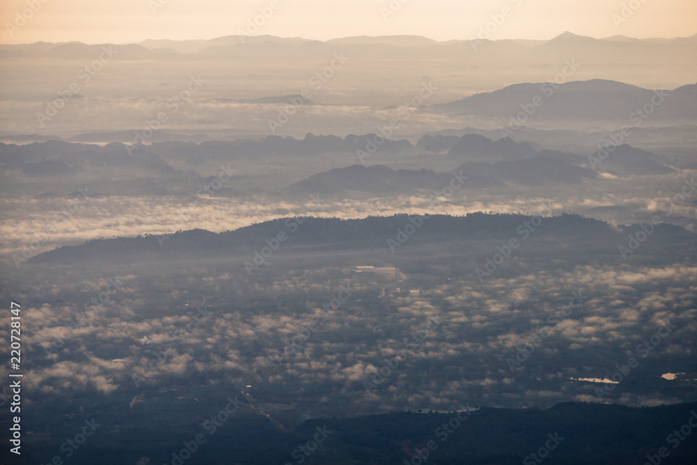 Background, high angle from the passenger plane. You can see the scenery by the distance (mountains, rivers, sky, fog, houses), the photos may be blurred during the flight. Background, high angle from the passenger plane. You can see the scenery by the distance (mountains, rivers, sky, fog, houses), the photos may be blurred during the flight.