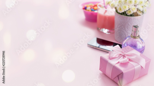 Banner Composition flat lay gift to a woman Modern gadget mobile phone glass cocktail perfume bouquet of flowers Preparing for the holiday surprise gift box pink background