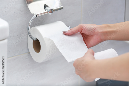 Close-up of Hand Using Toilet Paper.
