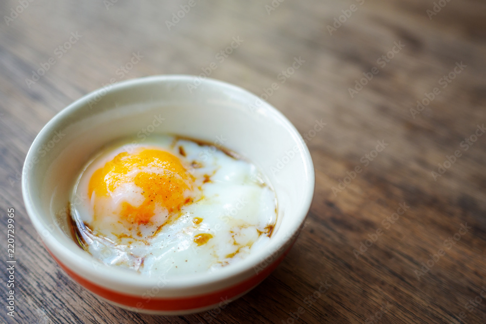 Onsen tamago egg or soft-boiled egg in traditional Japanese served with paper and shoyu soy sauce, copy space Onsen tamago egg or soft-boiled egg in traditional Japanese served with paper and shoyu soy sauce, copy space