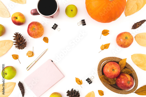 Thanksgiving dinner frame made of fall leaves, pine cones, mug of coffee, pink diary and apples with pumpkin on white background. Flat lay, top view