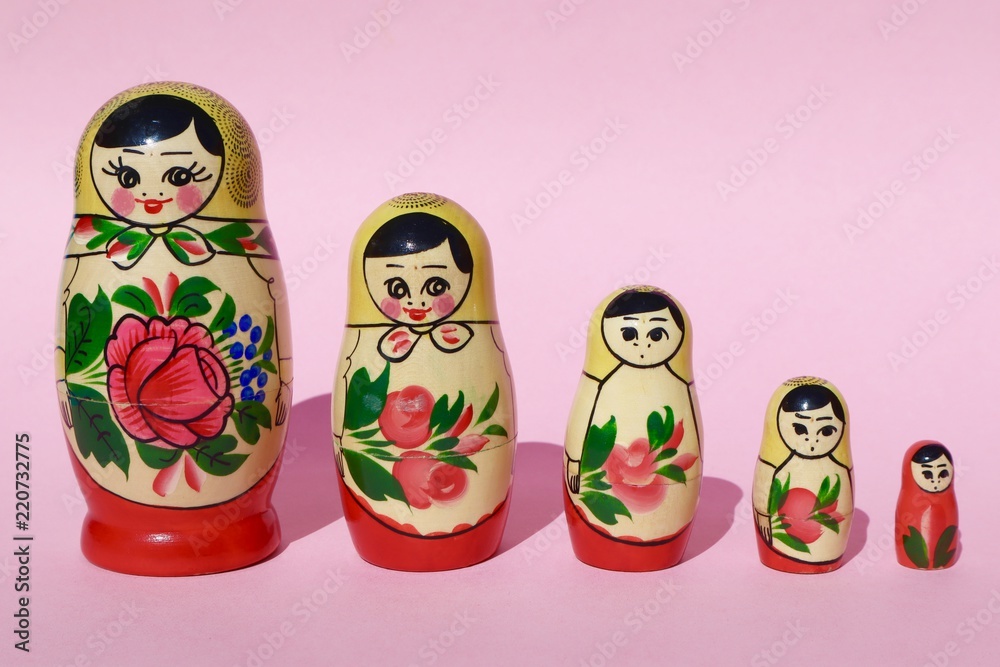Russian Babushka Nesting Dolls on Pink Background Russian Babushka Nesting Dolls on Pink Background