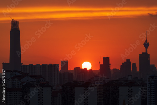 Photography Majestic sunset over KL Tower and surrounded buildings in downtown Kuala Lumpur, Malaysia