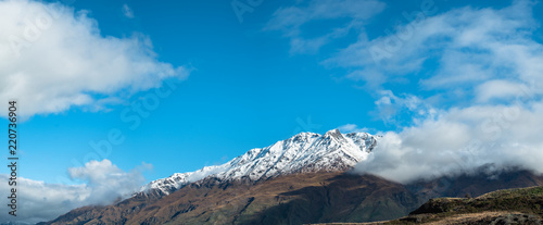 Stunning of the scenery of rocky mountain covered with snow after the raining day. Cloudy and foggy. Diamond lake track, Wanaka, New Zealand.