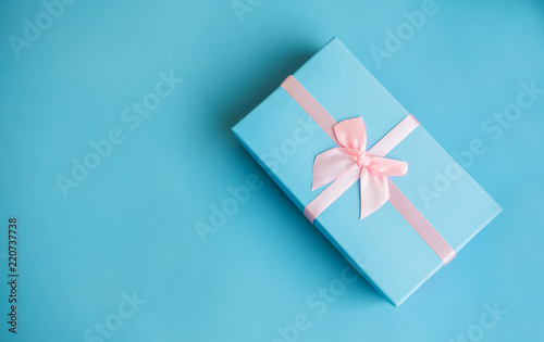 Festive holiday New Year and Christmas blue background with gift box. Concept of carnival  birthday  party. Flat lay. Top view.