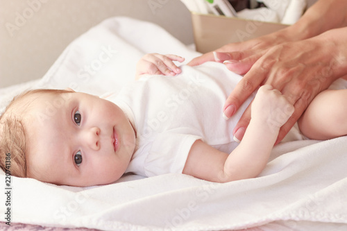 Baby and hands of mother, soft focus background