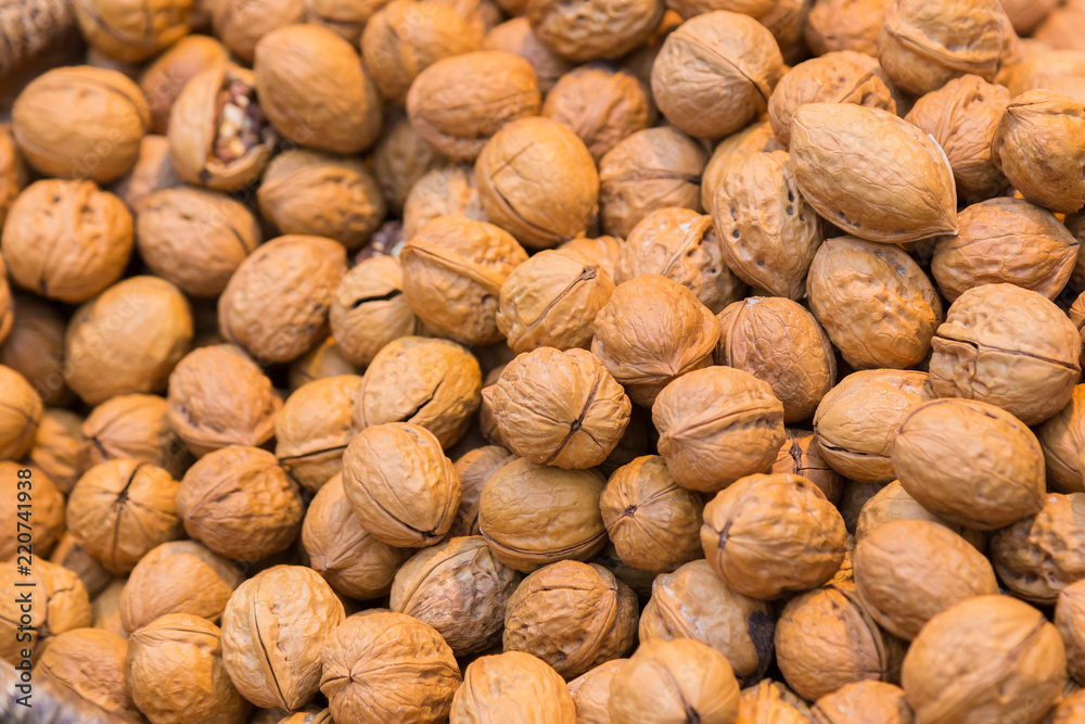 Pile of whole salted walnut with sheel Pile of whole salted walnut with sheel