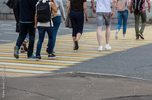 people walking on a pedestrian crossing