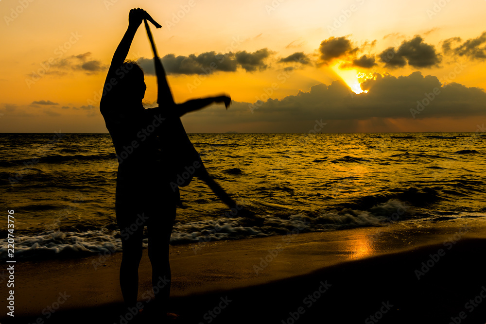 Silhouette women sunset on the beach