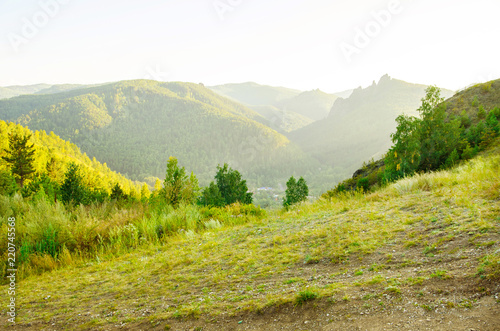 Paysage with mountains, hills and green trees. photo