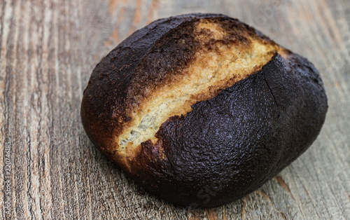 Verbranntes Brötchen auf Holztisch photo