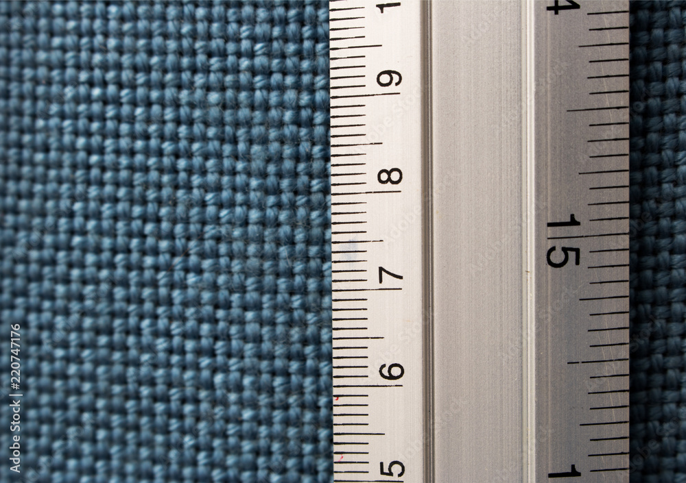 Close-up Ruler on blue fabricboard with copy space Close-up Ruler on blue fabricboard with copy space