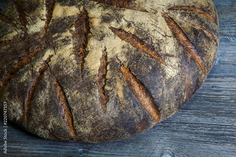 closeup big whole handmade round black bread closeup big whole handmade round black bread