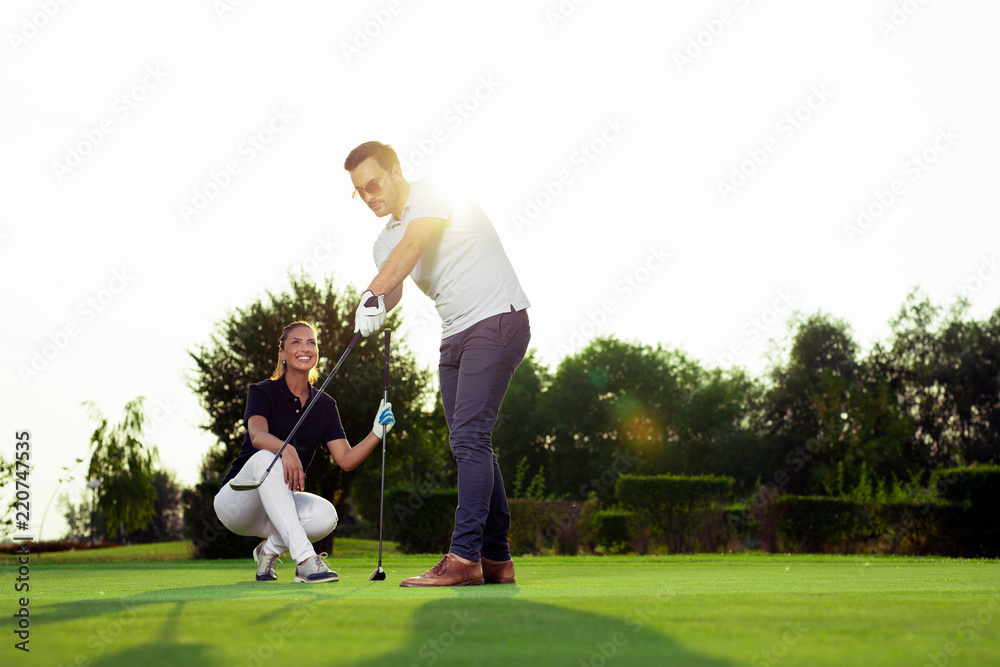 Couple playing golf together on golf course