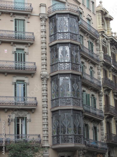 Fragment of the facade of a beautiful house with glazed balconies © HelenkaNNN