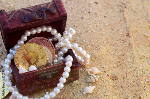 gold bitcoin treasures crypto currency mysterious treasure with pearl and sea shell on sand beach background with copy space