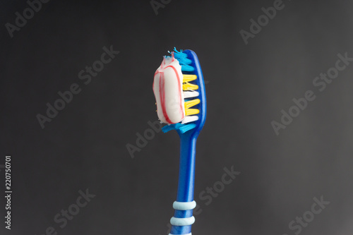 Toothbrush on a black background with selective focus and crop fragment