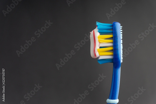 Toothbrush on a black background with selective focus and crop fragment