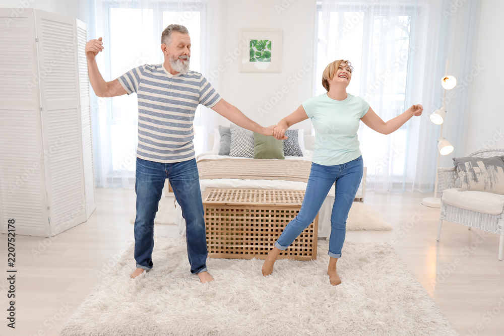 Fototapeta premium Happy mature couple dancing at home
