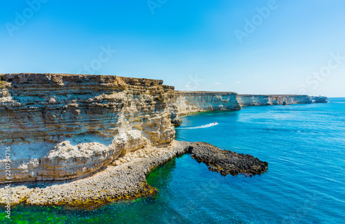 Beautiful view of blue sea and mountain. Calm water in bay with rock, sunny day