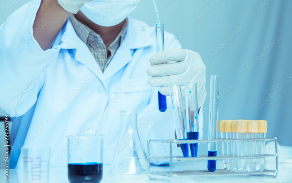 Fototapeta premium Close up. Medical or male medical in laboratory room research performs tests with blue liquid, Experimental Drug Treatment