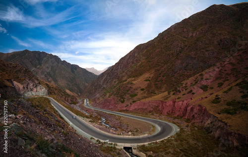 Serpentine road in Too-Ashuu pass and Kara Balta river and valley in Chuy Region of Kyrgyzstan photo