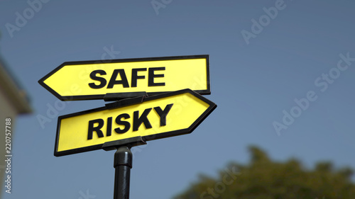 A road sign with safe risky words. 3d image. © Jane